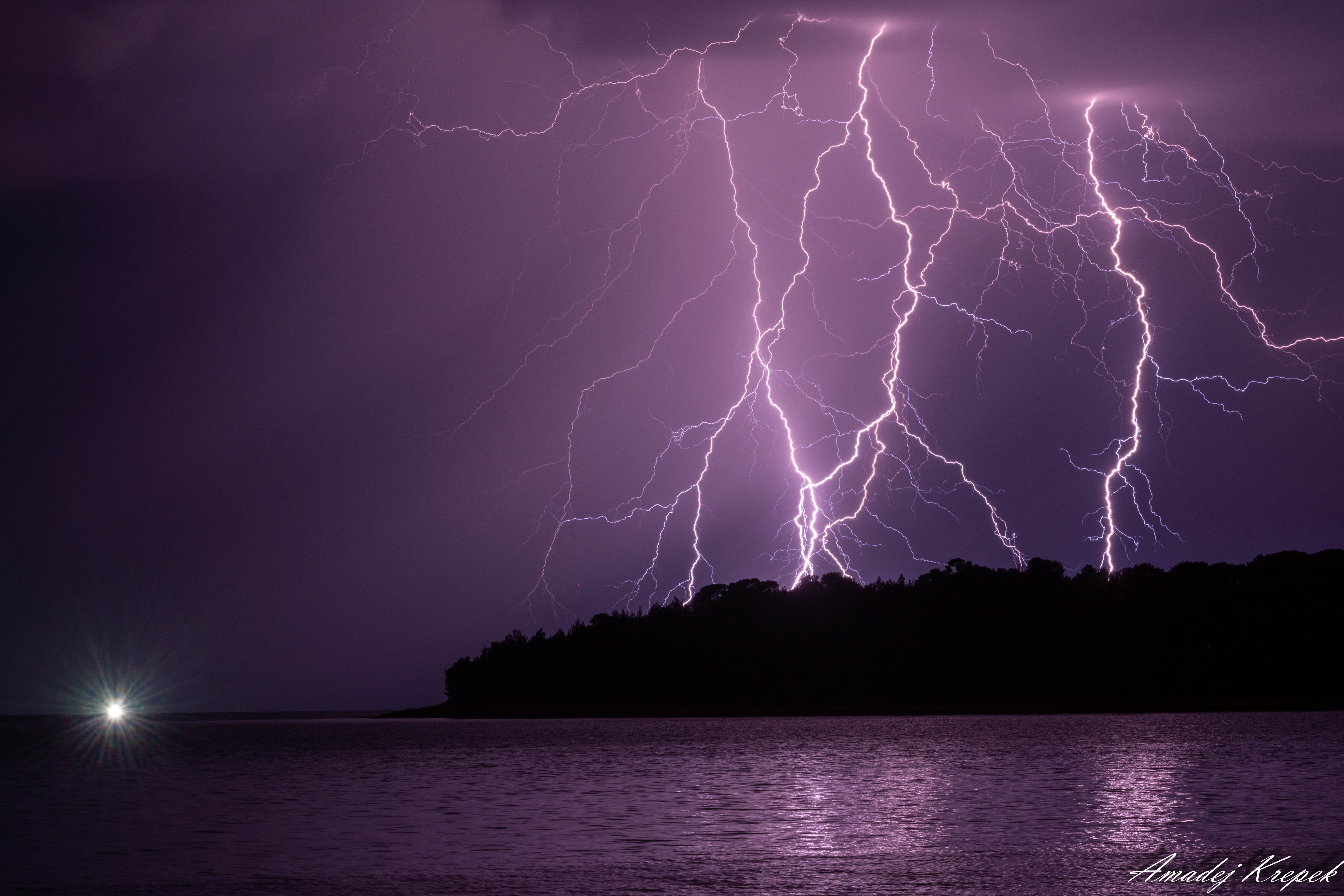 Lightning over lake at night